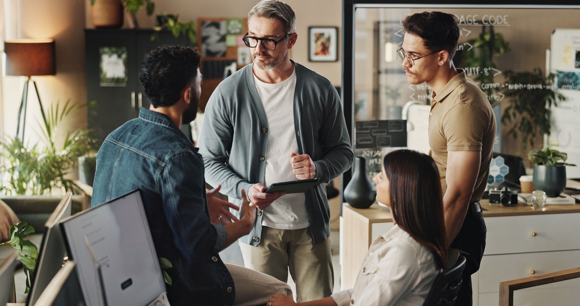 Teamwork, group of people and tablet in web design with collaboration, brainstorming and planning. Diversity, discussion and technology for project management, employee engagement and problem solving